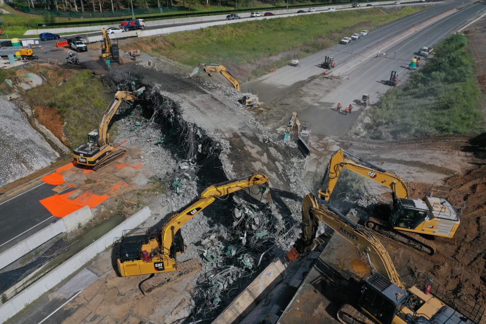 Abyss excavators continuing to work simultaneously to demolish the bridge.