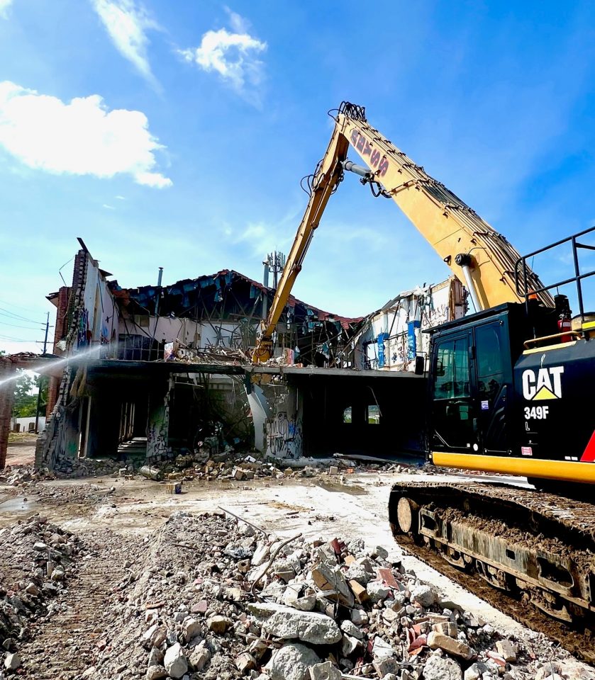 Building demolition with high reach excavator