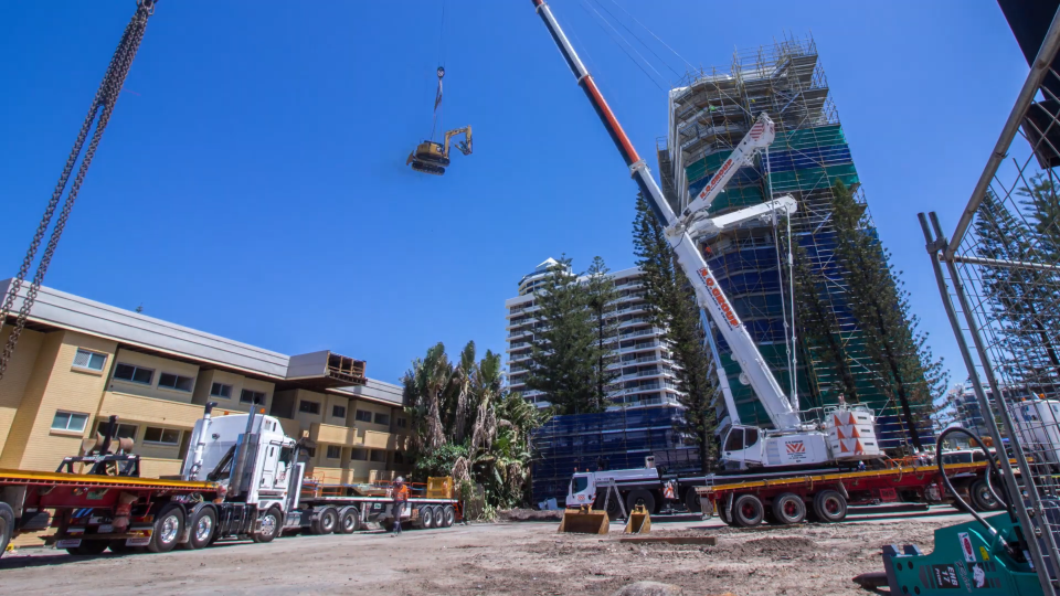 Jewel Project - Excavator being lifted by crane for high rise building demolition